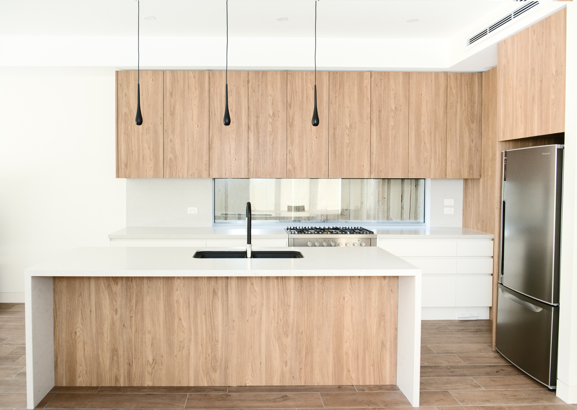Hands placing a stone benchtop